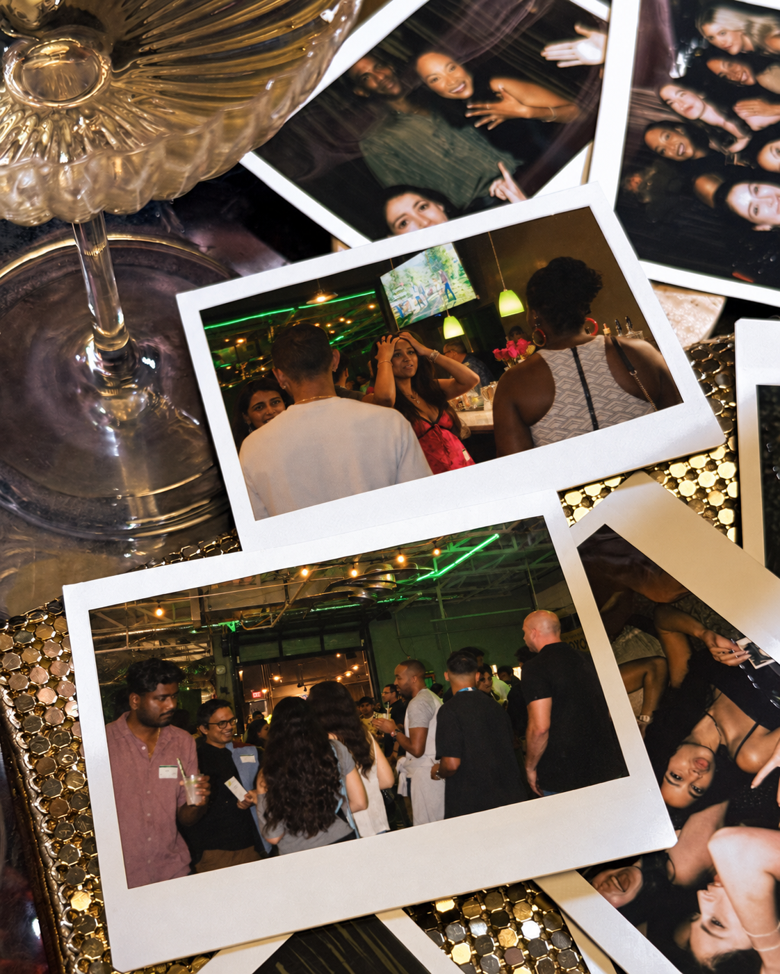 Polaroids from a past Ambo event scattered on a table
